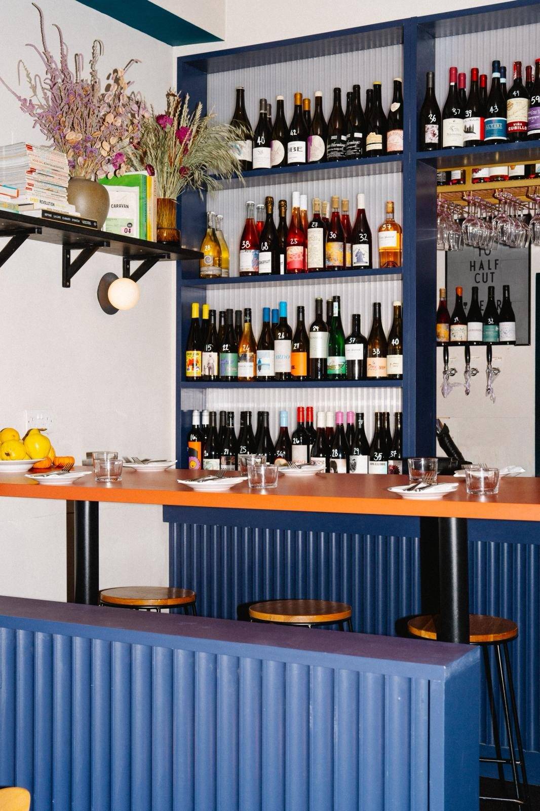The bar front and backbar, with the orange counter top and the pass to the kitchen
