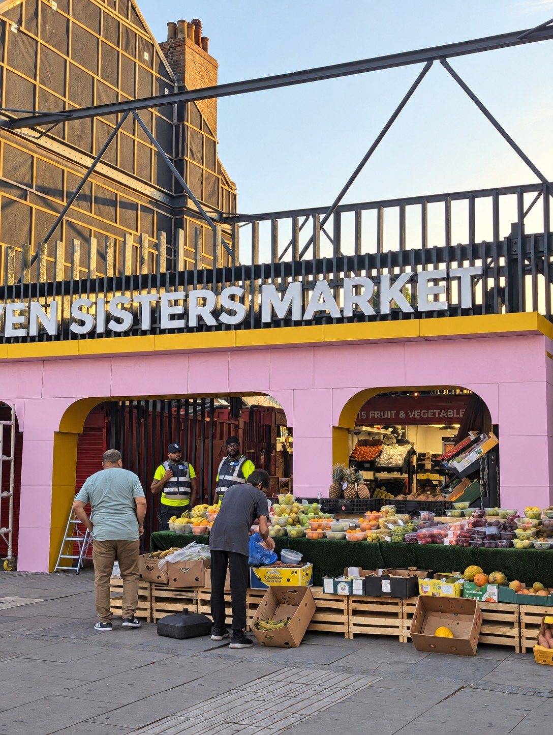 The stall front, set up for the day, with the market sign above