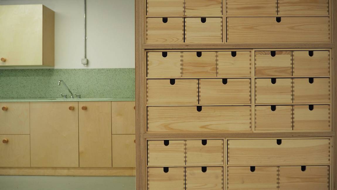 The education room, with its wall of small drawers and a sink